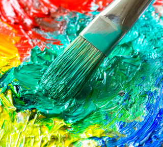 Art palette with colourful oil paints and brush
