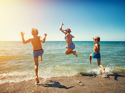 Children actively playing on a beach