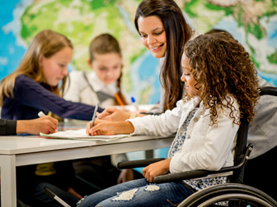 Girl with special educational needs in class at school