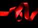 A red ribbon on a black background