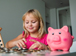 PSHE Economics quiz illustration | Girl saving money