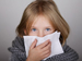 Child blowing her nose
