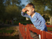 Child shielding his eyes from bright light