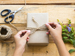 Child tying parcel with string
