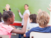 Class of children with raised hands