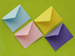 Four colorful envelopes on a green background