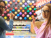 Two girls throwing darts in an amusement park