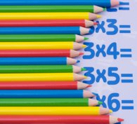 Maths tables partly concealed by pencils
